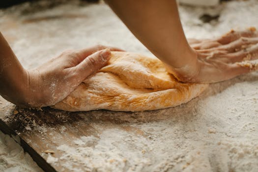 a baker kneading dough